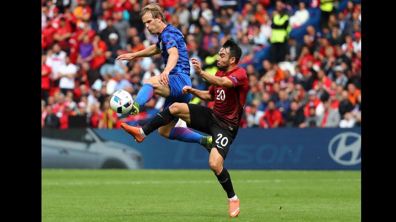 Turkey's Volkan Sen, right, competes against Croatia's Ivan Strinic.
