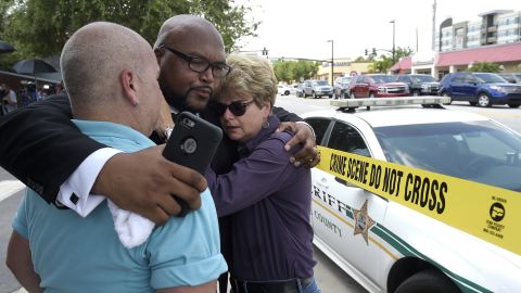 Pastor Kelvin Cobaris embraces Orlando City Commissioner Patty Sheehan, right, and Terry DeCarlo, executive director of the LGBT Center of Central Florida, on June 12.