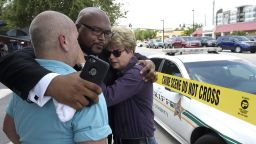 Terry DeCarlo, executive director of the LGBT Center of Central Florida, left, Kelvin Cobaris, pastor of The Impact Church, center, and Orlando City Commissioner Patty Sheehan console each other after the shooting at the Pulse nightclub in Orlando, Florida, Sunday, June 12.
