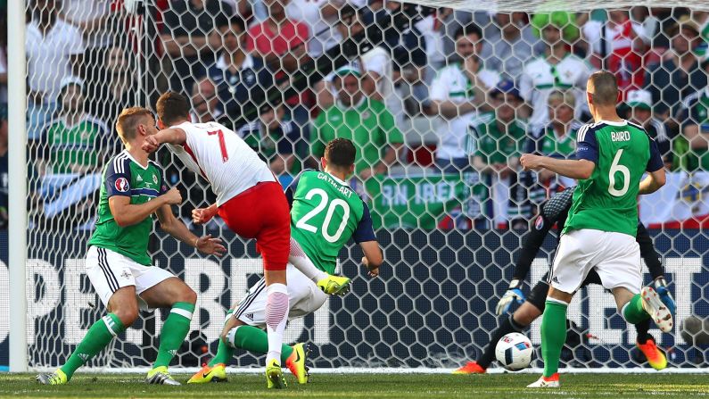 Poland's Arkadiusz Milik, second from left, scores a goal against Northern Ireland during their Euro 2016 opener in Nice, France. Poland won 1-0.