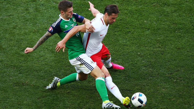 Poland's Grzegorz Krychowiak, right, competes for the ball with Northern Ireland's Oliver Norwood.