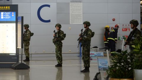 Armed troops inside Pudong airport seal off part of the arrivals terminal.