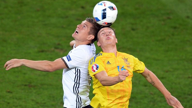 Germany's Toni Kroos, left, competes for the ball with Ukraine's Serhiy Sydorchuk.