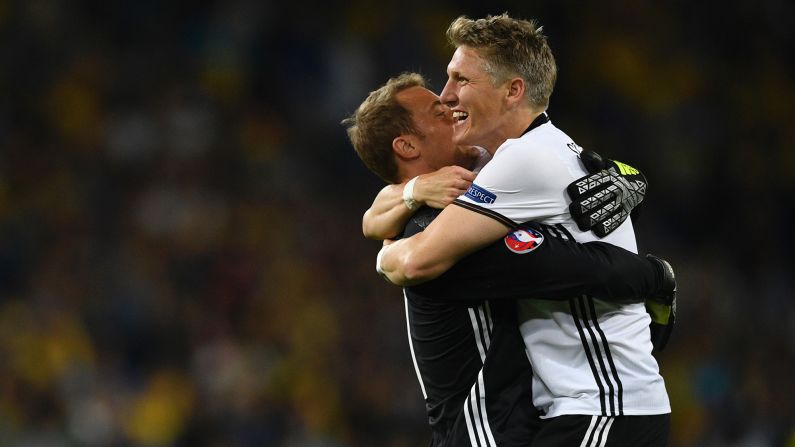 Schweinsteiger celebrates Germany's second goal with goalkeeper Manuel Neuer.
