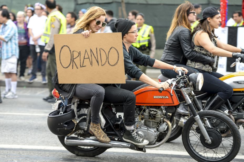 People show their support for Orlando during the Los Angeles gay pride parade.