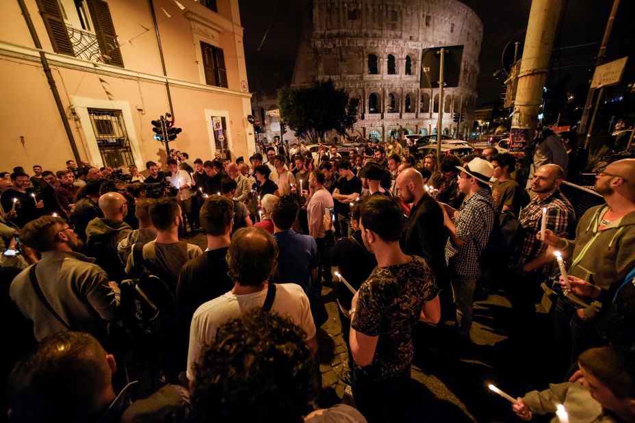 People hold candles near Rome's Colosseum as they take part in a ceremony on June 12.