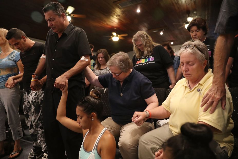 A man injured in the attack stands with other mourners as they attend a memorial service at an Orlando church.