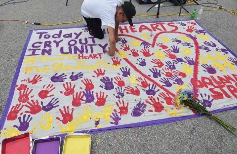 A man places a handprint on a makeshift memorial near the nightclub where the attack took place.