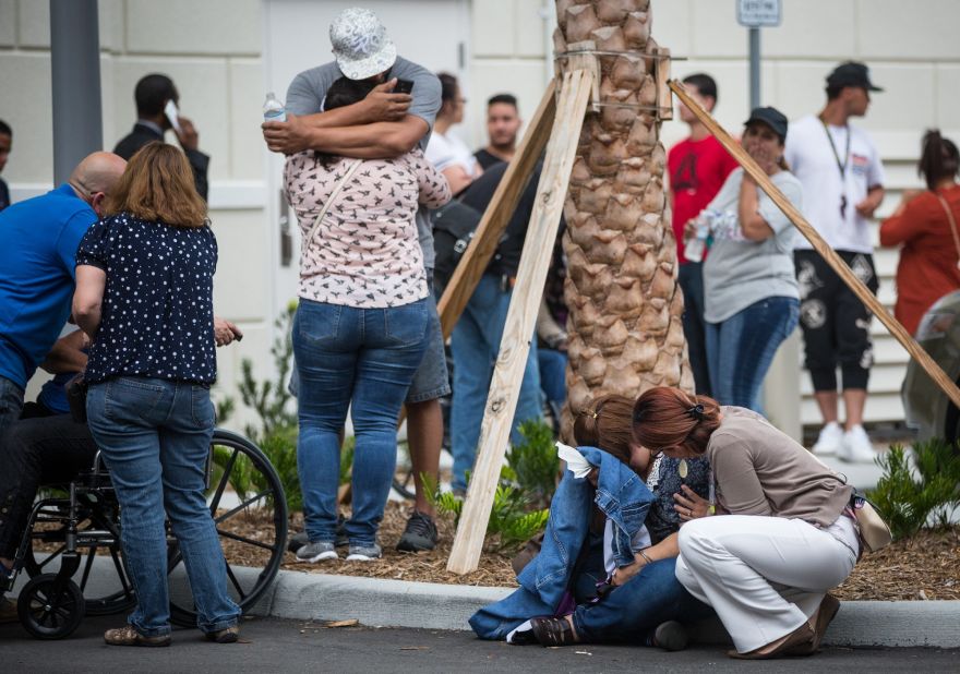 Friends and family react after a list of hospitalized victims is released June 12 outside a hotel near the Orlando Regional Medical Center.