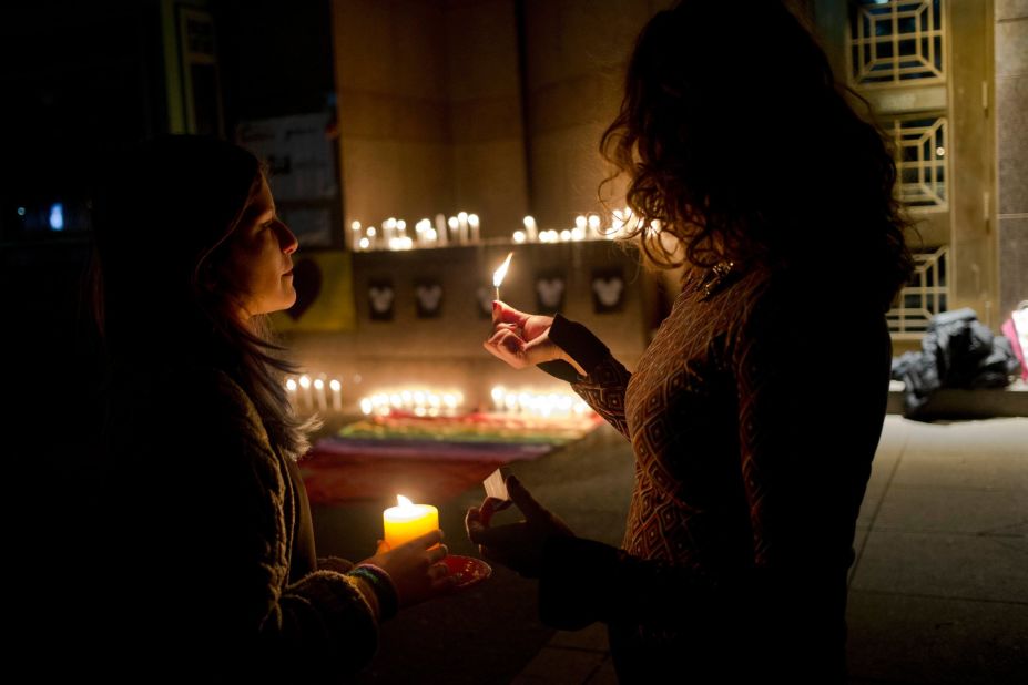 Two women light candles during a vigil in front of the U.S. Embassy in Santiago, Chile, on June 12. 