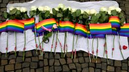 White roses and rainbow flags are displayed in front of the US Embassy in Berlin on June 13, 2016 as people pay tribute to the victims of the Orlando killing.
Fifty people died when a gunman allegedly inspired by the Islamic State group opened fire inside a gay nightclub in Florida, in the worst terror attack on US soil since September 11, 2001. / AFP / John MACDOUGALL        (Photo credit should read JOHN MACDOUGALL/AFP/Getty Images)
