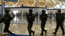 Paramilitary police officers patrol inside Pudong airport in Shanghai after an explosion near a check-in counter on June 12, 2016. 
A blast caused by "home-made" explosives injured four people and sparked a major security alert at the main international airport in China's commercial hub of Shanghai on June 12, according to the operator and state media. / AFP / STR / China OUT        (Photo credit should read STR/AFP/Getty Images)