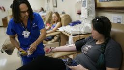 A technician prepares to take a plasma donation from Tiffany Stephens at OneBlood in Orlando.