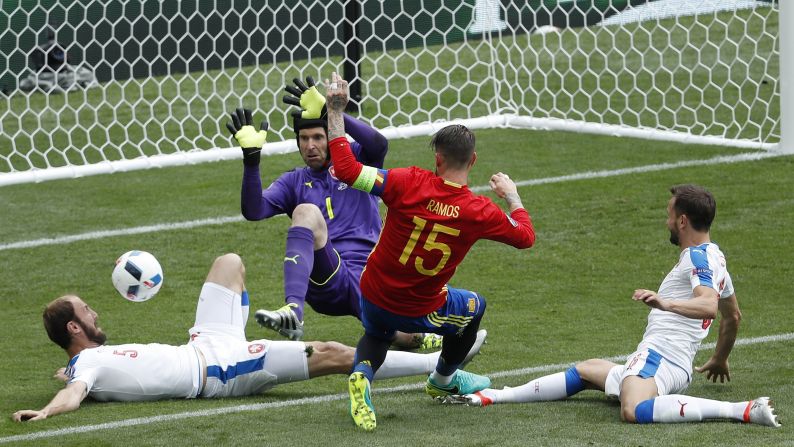 Spain's Sergio Ramos is denied during a goalmouth scramble.