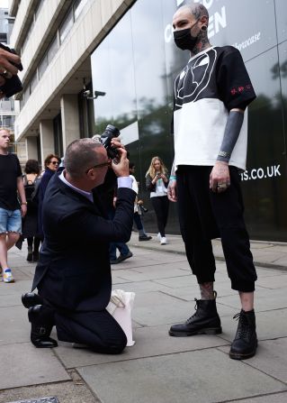 An unnamed man poses outside Nasir Mazhar's show.