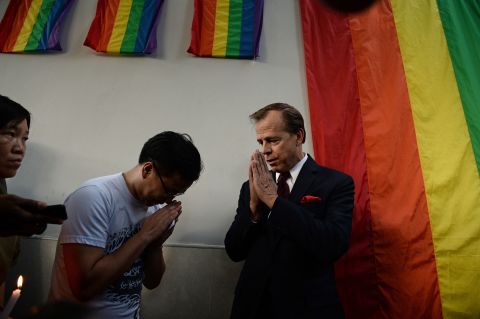 U.S. Ambassador to Thailand Glyn T. Davies, right, gestures to members of the LGBT community outside the U.S. Embassy in Bangkok, Thailand, on June 13. They were holding a vigil for the victims.