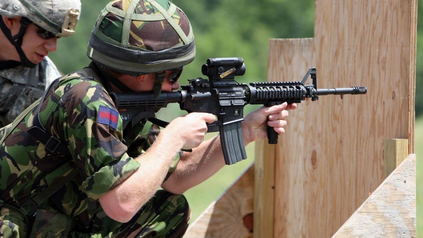 FILE - In this June 25, 2010, file photo Britain's Prince Harry fires a Colt M4 assault riffle on a United States Military Academy range in West Point, N.Y.  The Defense Department is searching for the successor to the M4 combat rifle and gun makers are loading with lobbyists to win the work. Colt Defense of West Hartford, Conn., had an exclusive deal to provide M4s to the U.S. military and didnt need a hired gun looking out for its interests in Washington. (AP Photo/Chad Rachman, Pool, File)