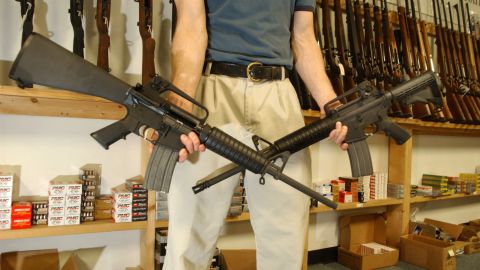 DENVER - SEPTEMBER 13: The Manager of Dave's Guns holds two Colt AR-15's, the gun on the right has a bayonet mount, flash suppressor and a collapsible stock and accepts high capacity magazines that hold over 30 rounds and can be purchased by civilians as of today, the gun on the left was legal to purchase and own with a 10 round magazine September 13, 2004 in Denver, Colorado. Between 1994 and September 13, 2004 the AR-15 with the above items could only be sold to law enforcement and military but is now legal for civilians to purchase due to the expiration of the Brady Bill. (Photo by Thomas Cooper/Getty Images)