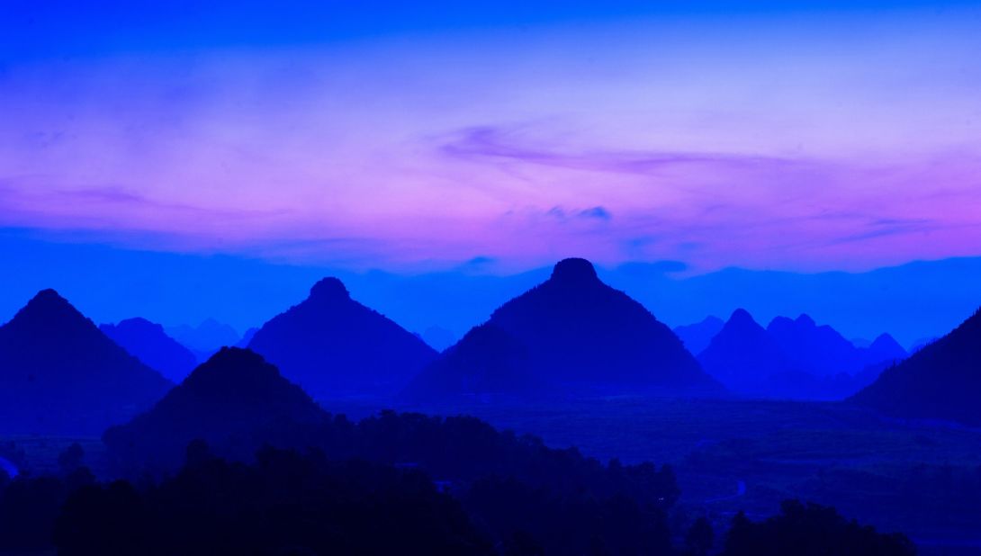 The Buyi hill tribe believes these conical karst hills in southern Guizhou resemble a pair of gigantic female breasts. On festival days, locals gather at the foot of the peaks and pay thanks to the "holy breasts" for healthy children, prosperity and safety.