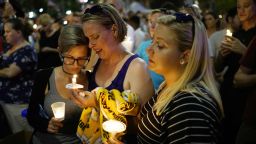 Women hold candles during a vigil for the victims of the Pulse nightclub shooting, on June 13, 2016 at the Dr. Phillips Center for the Performing Arts in Orlando, Florida.
The American gunman who launched a murderous assault on a gay nightclub in Orlando was radicalized by Islamist propaganda, officials said Monday, as they grappled with the worst terror attack on US soil since 9/11. 
 / AFP / MANDEL NGAN        (Photo credit should read MANDEL NGAN/AFP/Getty Images)