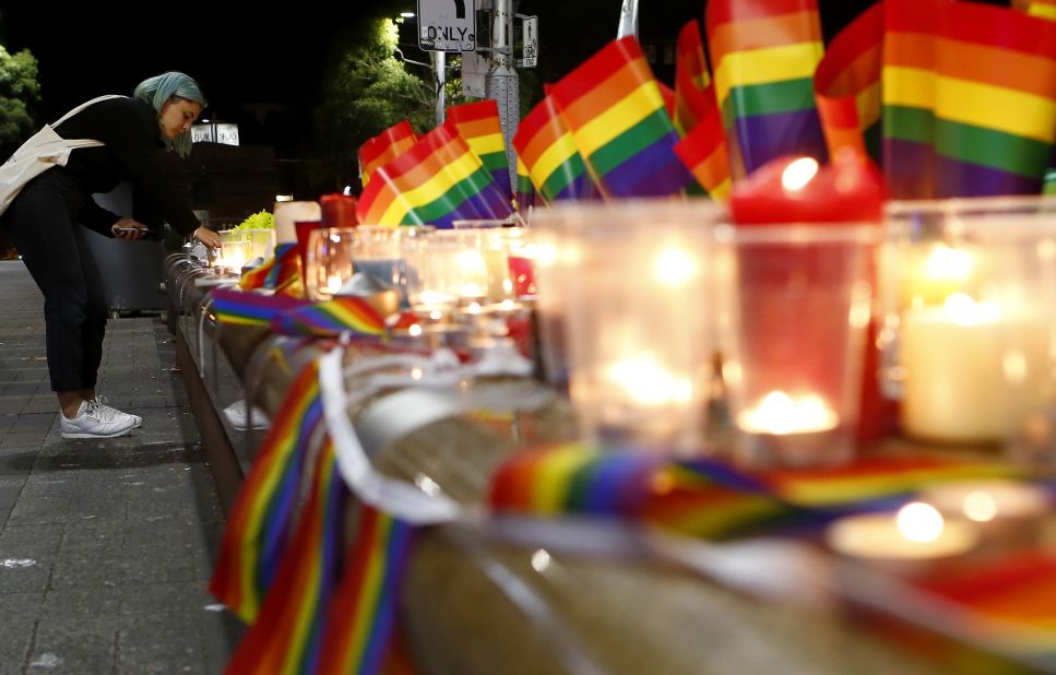 A woman lights a candle during a vigil in Sydney on June 13.