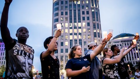 The crowd holds up candles during a moment of silence for the victims.