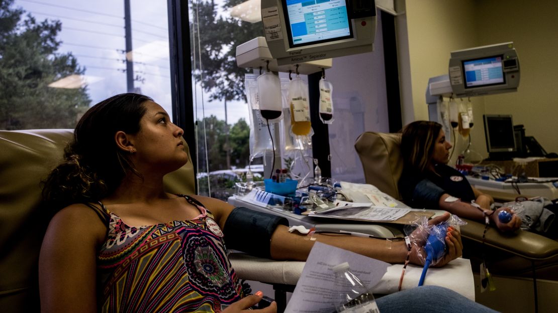 Meaghan McGurr and Xaymarie Torres donate blood Monday at One Blood, a non-profit blood bank.