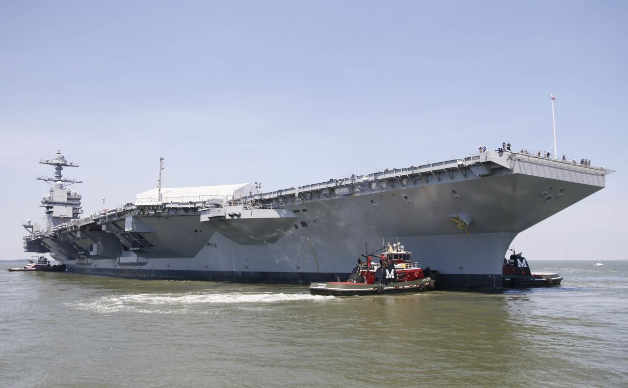 Tug boats maneuver the aircraft carrier Pre-Commissioning Unit Gerald R. Ford (CVN 78) into the James River during the ship's turn ship evolution on June 11, 2016. This is a major milestone that brings the country's newest aircraft carrier another step closer to delivery and commissioning later this year.