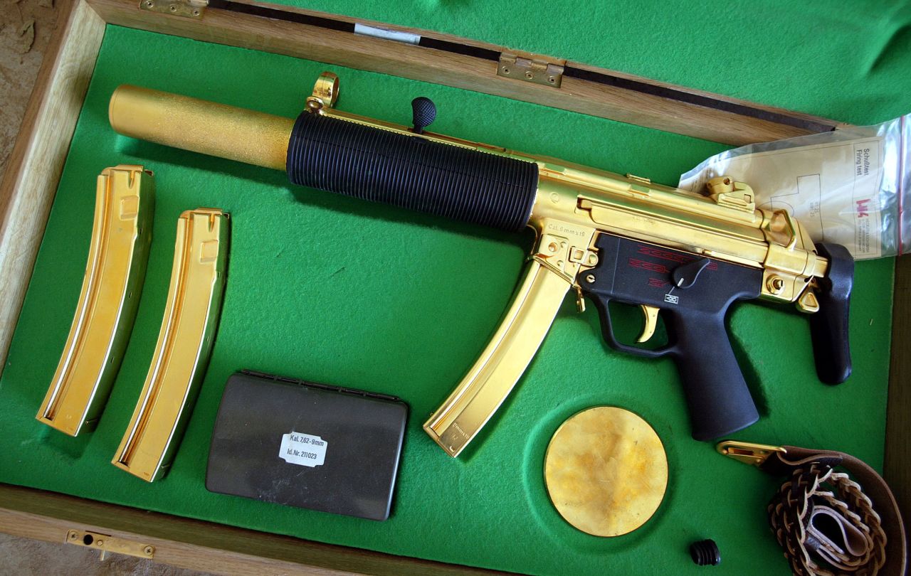 A gold-plated ceremonial MP5 submachine gun was displayed after its discovery near the Saddam Hussein's Republican Presidential Palace on April 14, 2003 in Bagdhad, Iraq. The weapon is designed to be stealthily fired while the briefcase is closed.