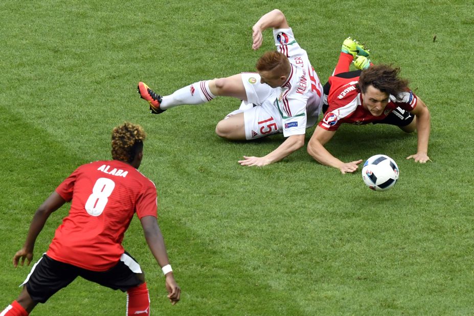 Austrian midfielder Julian Baumgartlinger, right, clashes with Hungarian midfielder Laszlo Kleinheisler.