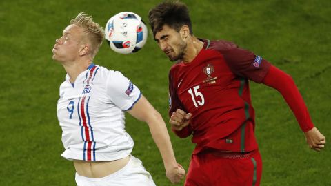 Iceland's Kolbeinn Sigthorsson, left, jumps for a header with Portugal's Andre Gomes.