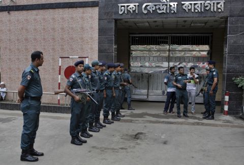 Bangladeshi policemen stand guard outside the Dhaka Central Jail.