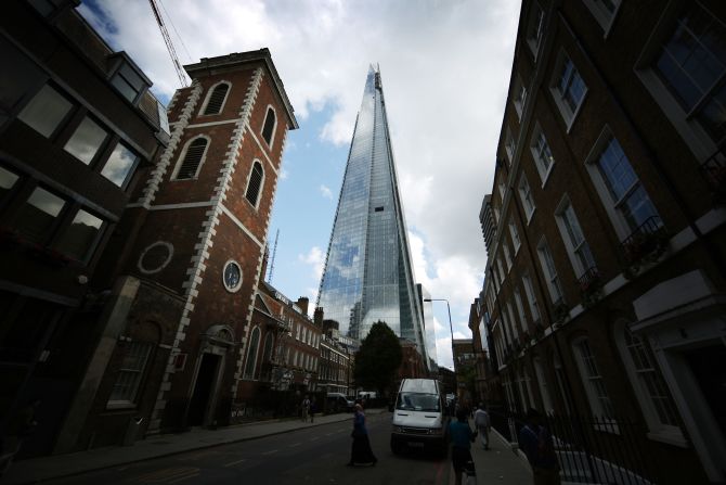 The Shard towers over St Thomas Street in London, England.
