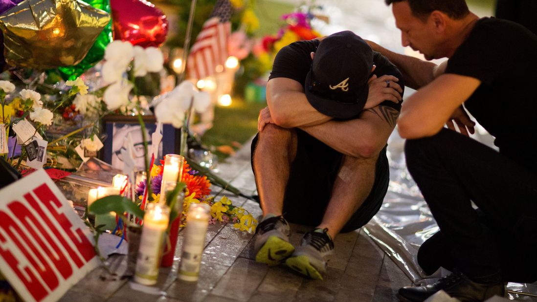 Jean Dasilva, left, is comforted by Felipe Soto as they mourn the loss of their friend Javier Jorge-Reyes on June 14. They were visiting a makeshift memorial at Pulse, the gay nightclub where the shooting took place.