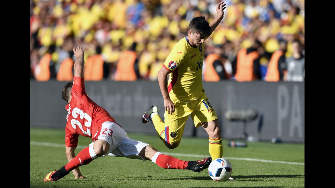 Romanian defender Steliano Filip is challenged by Switzerland's Xherdan Shaqiri.