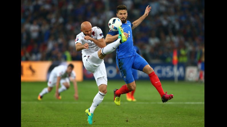 Albania's Arlind Ajeti, left, defends against French striker Olivier Giroud.