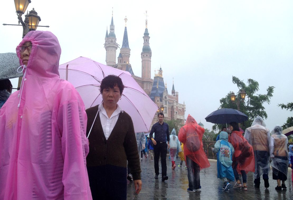 Theme Park Guy Stefan Zwanzger (behind the lady with the pink umbrella) braved the rains to get a preview of Shanghai DIsneyland.
