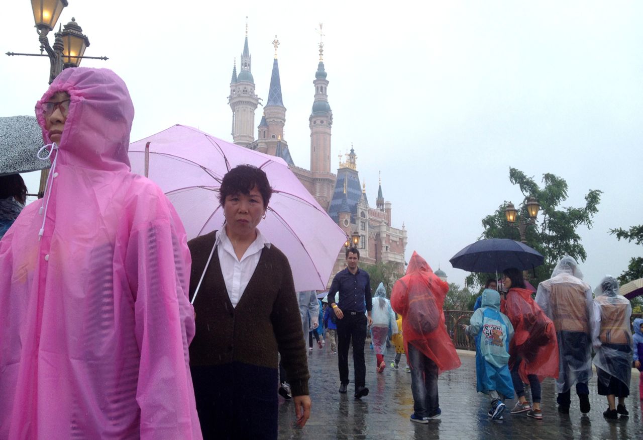 Theme Park Guy Stefan Zwanzger (behind the lady with the pink umbrella) braved the rains to get a preview of Shanghai DIsneyland.