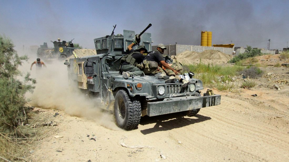 Iraqi security forces evacuate an injured soldier during fighting with ISIS militants on Wednesday, June 15.