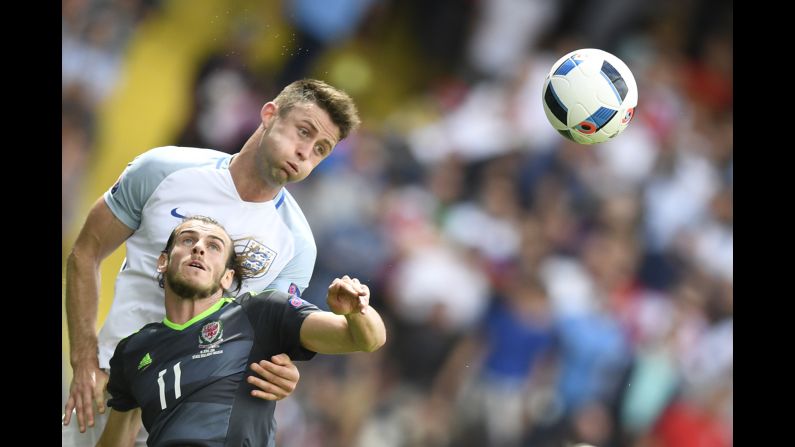England defender Gary Cahill heads the ball away from Bale.