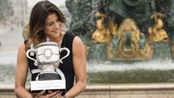 Spain's Garbine Muguruza poses for photographers with her trophy one day after winning her women's final match against US player Serena Williams at the Roland Garros 2016 French Tennis Open on June 5, 2016 at Place de la Concorde in Paris. / AFP / MARTIN BUREAU        (Photo credit should read MARTIN BUREAU/AFP/Getty Images)