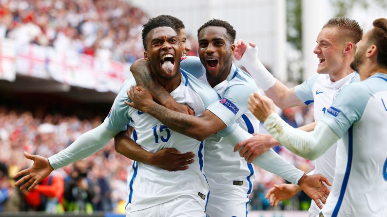 Daniel Sturridge, left, is mobbed by his England teammates after scoring a stoppage-time winner against Wales in Lens, France. England won 2-1.