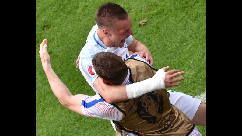 England substitute Jamie Vardy, top, embraces a teammate after tying the match in the 56th minute.