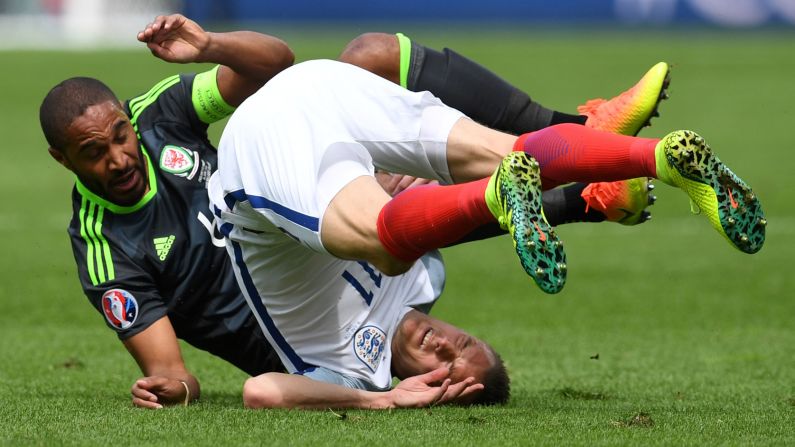 Vardy falls over after colliding with Welsh defender Ashley Williams.