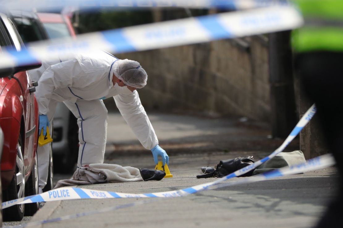 Forensic police examine the scene of the attack.