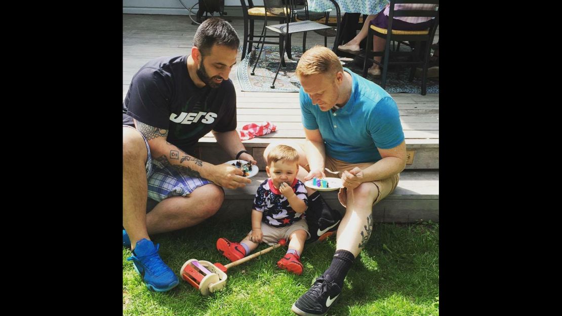 Rocco Forgione, left, his husband, Corey Martin, and their son, Forge, 2.