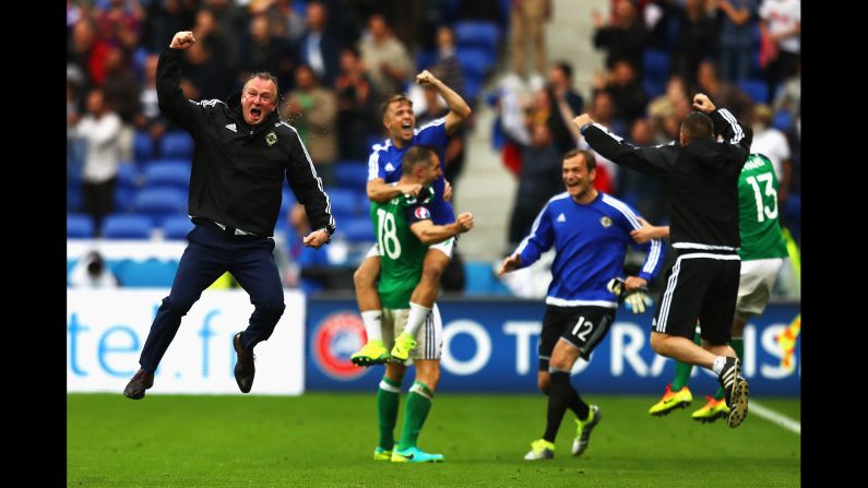 Northern Ireland manager Michael O'Neill, left, celebrates a late goal during a 2-0 victory over Ukraine in Lyon, France.