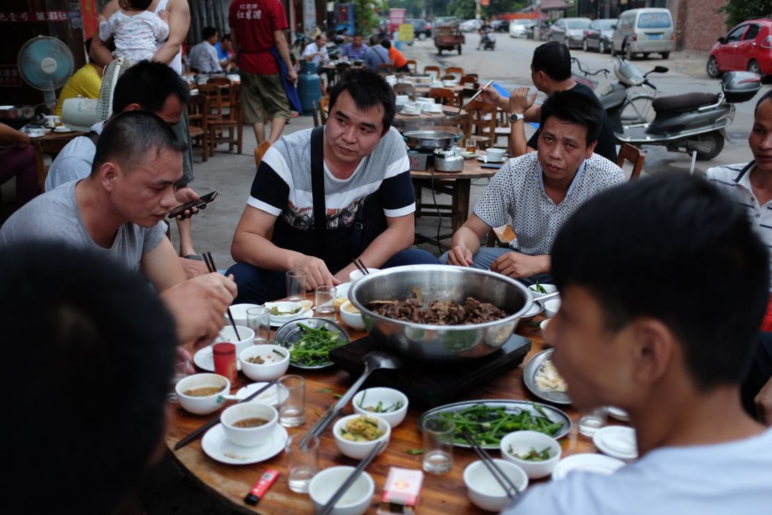 This photo taken on May 9, 2016 shows people eating dog meat at a restaurant in Yulin, in China's southern Guangxi region.
