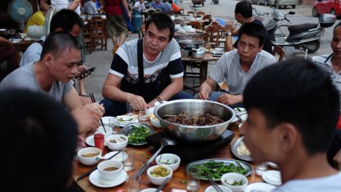 This photo taken on May 9, 2016 shows people eating dog meat at a restaurant in Yulin, in China's southern Guangxi region.
