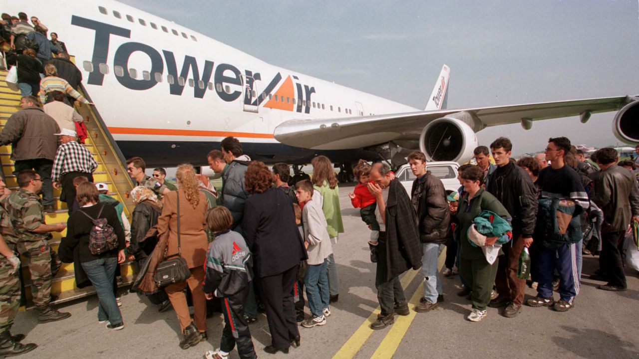 Ethnic Albanian refugees wait in Skopje, Macedonia, to board a flight for Fort Dix, New Jersey, in 1999. They were part of an exodus of 200,000 people from war-torn Kosovo.